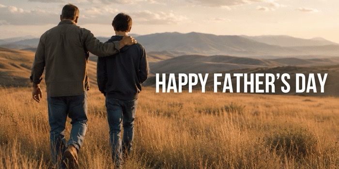 A father walks with his son across an open field at golden hour — Happy Father's Day